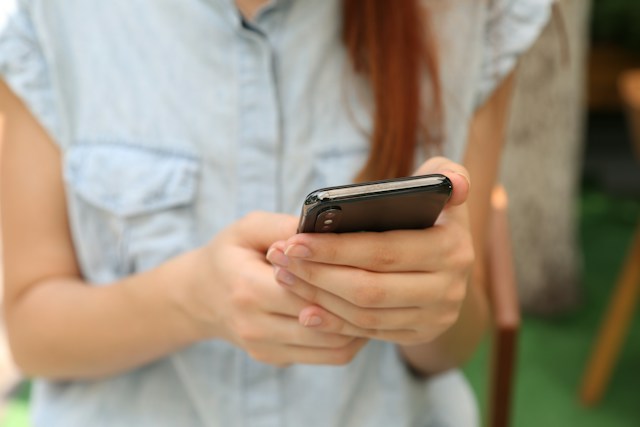 close-up of woman holding smartphone