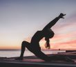 woman stretching at sunset