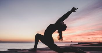 woman stretching at sunset