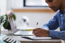 man with laptop and notebook