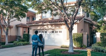 Roofing Tips to Keep Your Driveway and Car Protected couple looking at their house