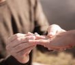 man giving woman engagement ring