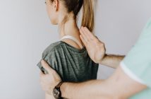 woman getting back examination