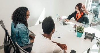 couple with loan officer at bank