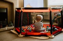 toddler in playpen view from behind