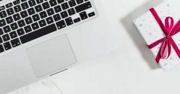 laptop and wrapped gift box on table