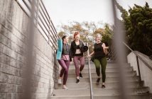 group of four women walking down steps outside