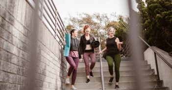 group of four women walking down steps outside