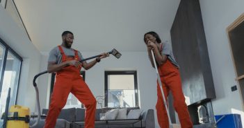 man and woman in orange jumpsuits cleaning home
