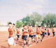 group of young men running track