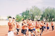 group of young men running track