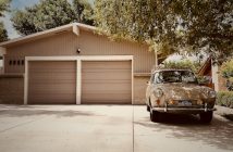 classic car next to a garage