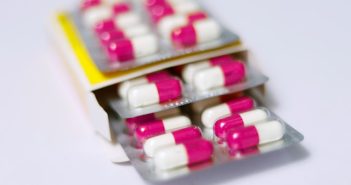 red and white pills in plastic