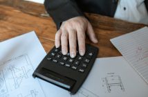 closeup of hand using calculator