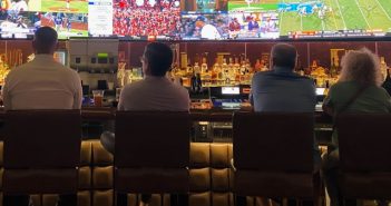 rear view of men watching games in casino sportsbook