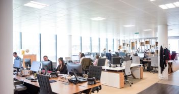 open office area with workers working at their desks