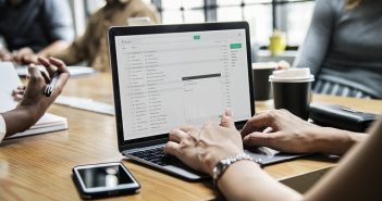 woman's hands on a laptop on desk