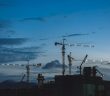 cranes on building contruction at dusk
