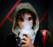 man in hoodie vaping