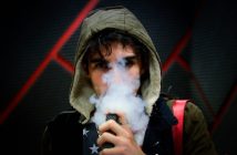 man in hoodie vaping