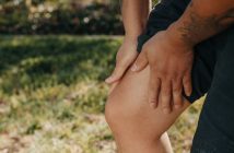 closeup of man's leg with man holding it