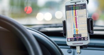 smartphone with map mounted on vehicle dashboard