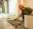 construction worker laying tile