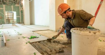 construction worker laying tile