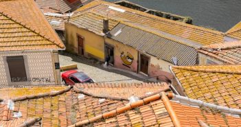 ariel views of homes and red car on road