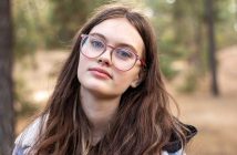 Pretty woman with long brown hair and glasses