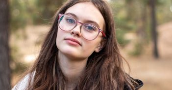 Pretty woman with long brown hair and glasses