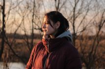 attractive brunette woman in red coat outside