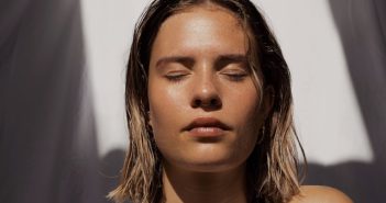 close-up of pretty blonde woman with eyes closed and sun shiining on her face