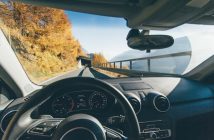view from driver's seat in car on road heding to tunnel with trees along the road