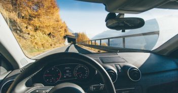 view from driver's seat in car on road heding to tunnel with trees along the road