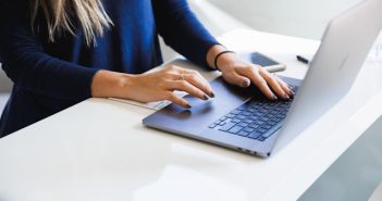 close-up of woman's hands on laptop