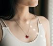 close-up of necklace on beautiful brunette woman in off white top