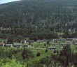historic ghost town in mountain valley with trees