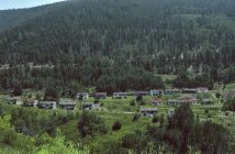 historic ghost town in mountain valley with trees
