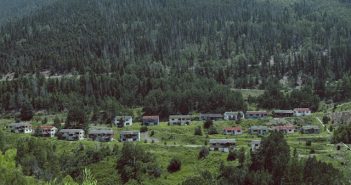 historic ghost town in mountain valley with trees