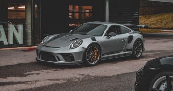 light gray Porsche sports car parked in street