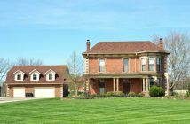large house with green lawn and driveway
