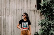 brunette woman in black t-shirt with design