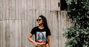 brunette woman in black t-shirt with design