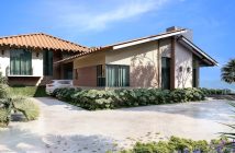 house in suburbs with car parked out front