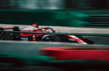 red Formula 1 car on course
