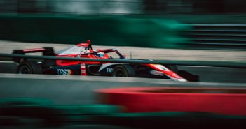 red Formula 1 car on course