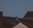 construction worker with red hardhat on roof