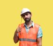 maintenance worker in hard hat and orange vest