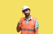 maintenance worker in hard hat and orange vest